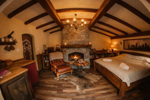 a bedroom with a bed and a fireplace at Mobbiton Mostar - Magical Underground Retreat in Mostar