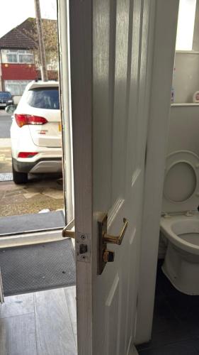 an open door to a bathroom with a toilet at Bel City in Thornton Heath