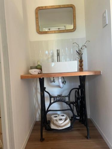 a bathroom vanity with a sink and a mirror at Casa Lobos en Chapadmalal in La Estafeta