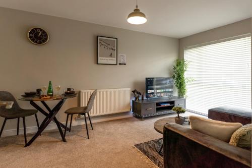 a living room with a couch and a table at Solihull House - Free Parking, NEC, Airport in Solihull