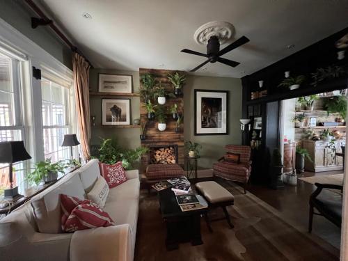 a living room with a couch and a ceiling fan at Stylish Mission-Style Home on Park in Jersey City, NJ in Jersey City