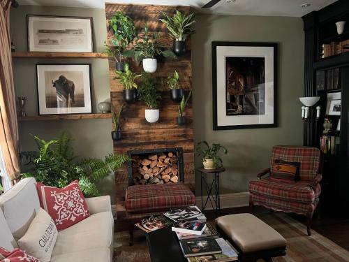 a living room with a couch and a fire place at Stylish Mission-Style Home on Park in Jersey City, NJ in Jersey City