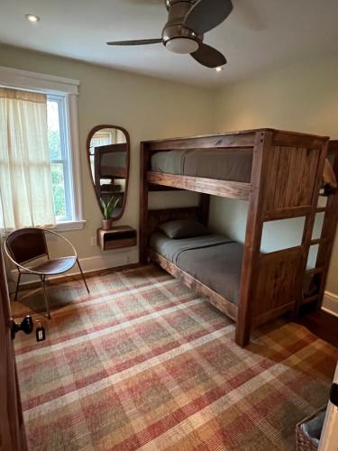a room with a bunk bed and a mirror at Stylish Mission-Style Home on Park in Jersey City, NJ in Jersey City