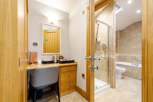 a bathroom with a sink and a shower at Waterhead Retreat, Ground Floor Bathtub Suites with Private Entrance in Ambleside