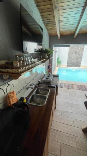 a kitchen with a sink and a swimming pool at Cassara Retreat in La Consulta