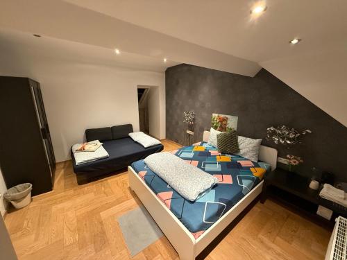 a bedroom with a bed and a couch in a room at The Beautiful White Villa in Kortenberg