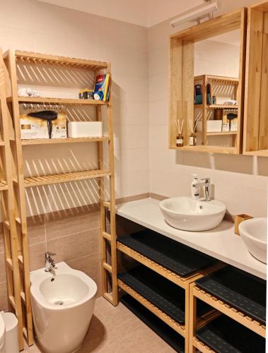 a bathroom with two sinks and a mirror at Le Cervin Lodge in Breuil-Cervinia