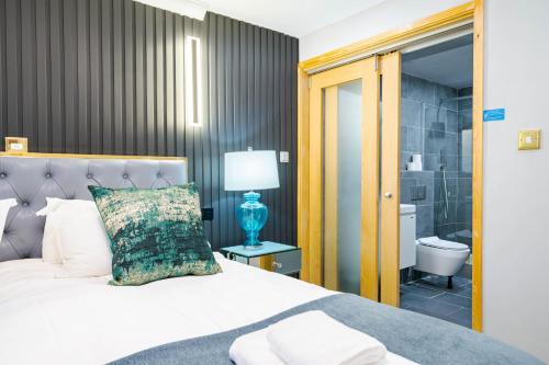 a bedroom with a bed and a bathroom at Waterhead Rooms & Suites - Parking Available Onsite in Ambleside