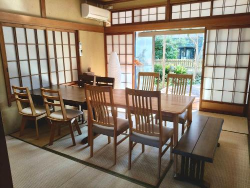 a dining room with a wooden table and chairs at The house of calmness in Beppu