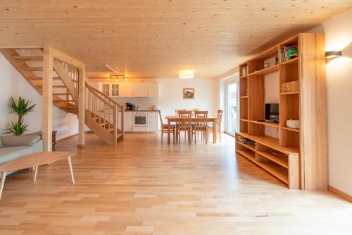 a living room with a staircase and a dining room at Sigelalp in Blaichach