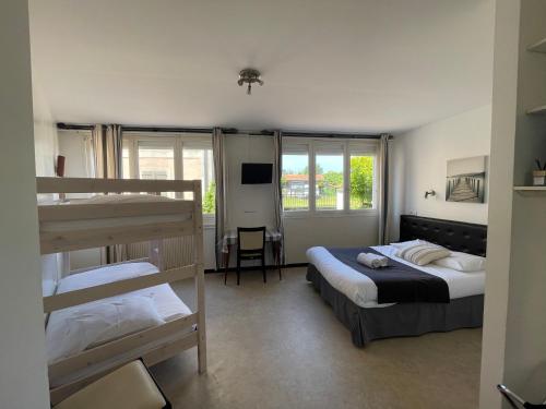 a bedroom with two beds and a bunk bed at Auberge Les Mufliers - Hôtel Les Forges in Pontenx-les-Forges