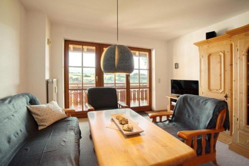 a living room with a couch and a table at StaigAllgäublick in Sonthofen