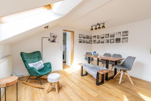 a living room with a table and chairs at Spitzkehren in Blaichach