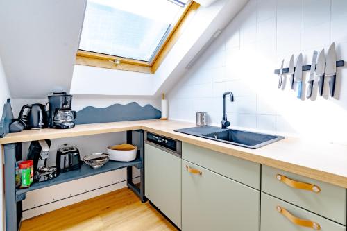 a small kitchen with a sink and a window at Spitzkehren in Blaichach