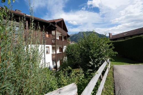 a building with a fence next to a road at Gipfelliebe in Bad Hindelang