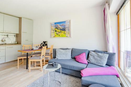a living room with a blue couch and a table at Ferienwohnung Manns in Bad Hindelang