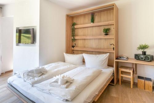 a bedroom with a bed with white sheets at Ferienwohnung Manns in Bad Hindelang