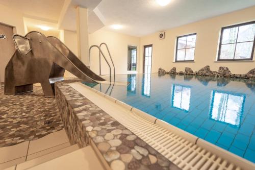 a swimming pool with a slide in the middle at Bergfriede in Bad Hindelang