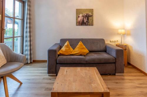 a living room with a couch and a coffee table at Bergfriede in Bad Hindelang
