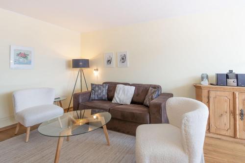 a living room with a couch and two chairs and a table at Ifen in Fischen