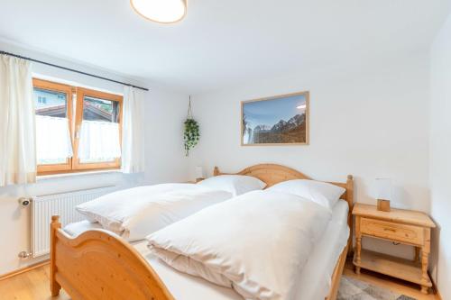 a bedroom with two beds with white sheets at Stolz 1 in Blaichach