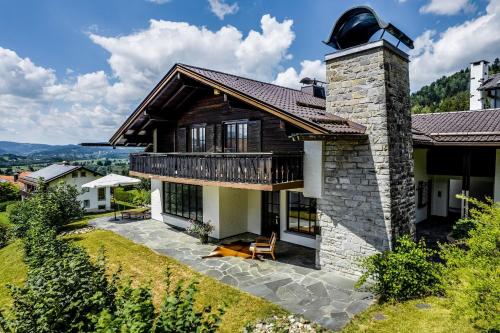 a house with a deck and a balcony at Landhaus Hoch 10 in Burgberg