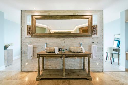 a bathroom with a sink and a mirror at Tinwood Estate Vineyard Lodges in Chichester