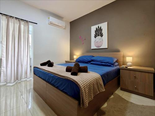 a bedroom with a large bed with blue sheets at Modern House with Pool - 10 Guests Max in Taʼ Ċantar