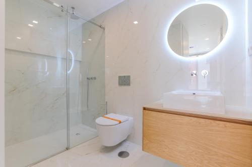 a bathroom with a shower and a toilet and a sink at D'AUSE - New Modern Apt - 150m to Beach & Center in Esposende
