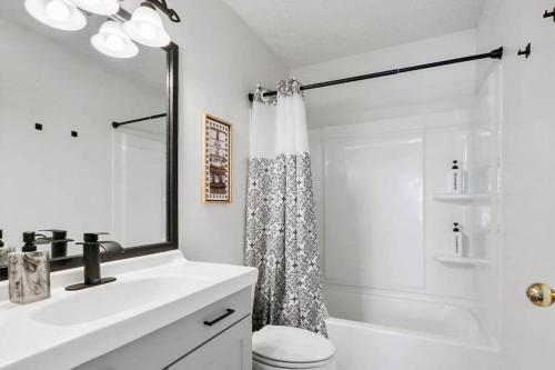 a white bathroom with a sink and a shower at Spacious King Suite, Horses, Fire Pit, Garage in Lexington
