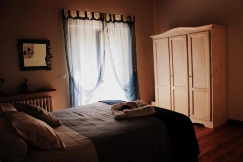 a bedroom with a bed and a large window at Campo Del Mare in Sirolo