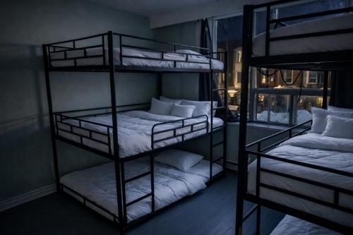 two sets of bunk beds in a room at Zen Hostel in Toronto
