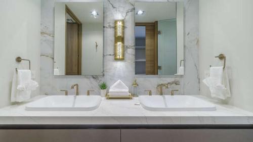 a bathroom with two sinks and a large mirror at Beachfront Luxury Studio in Puerto Peñasco