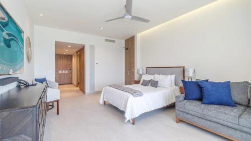 a hotel room with a bed and a couch at Beachfront Luxury Studio in Puerto Peñasco