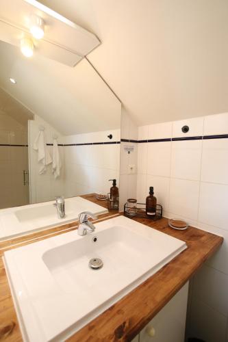 a bathroom with a white sink and a mirror at Les Cimes - Le Tholy in Le Tholy