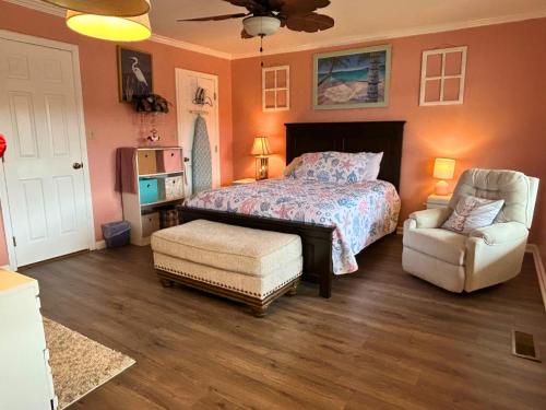 a bedroom with a bed and a chair at Lake House in Phil Campbell