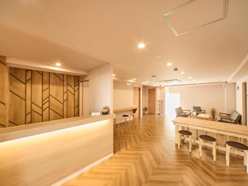 an office lobby with a reception desk and chairs at Southern Gate HIVE in Ishigaki Island