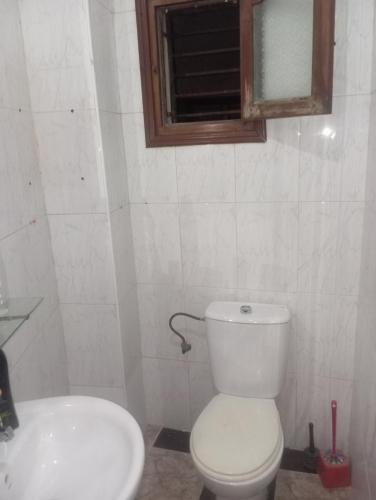 a bathroom with a white toilet and a sink at Tetuan in Tétouan