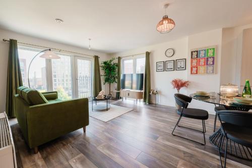 a living room with a couch and a table at City Central - Free Private Parking, O2, University in Birmingham