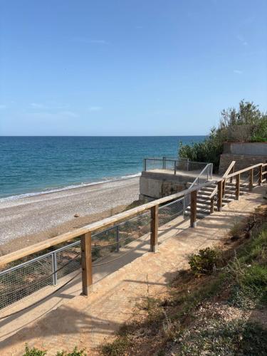 a stairway to the beach with the ocean in the background at CHALET directo al MAR in Benicarló