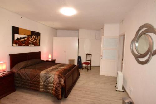 a bedroom with a bed and a mirror on the wall at Room 2 - Music House in Bicas
