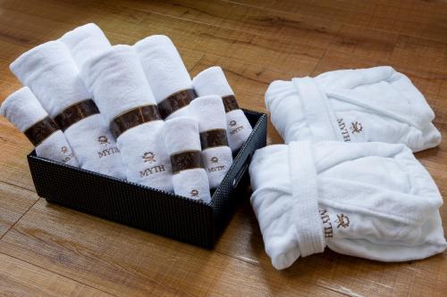 a box of towels and socks on a wooden floor at HOTEL MYTH-U -Adult only in Wakayama