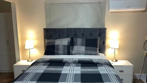 a bedroom with a bed with two lamps at Cozy Ground-Floor Room with Private Bath and Separate Entry in Delta