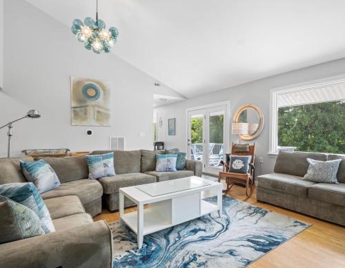 a living room with a couch and a table at Exceptional Contemporary Retreat with 4 King Beds in Mystic CT in Groton