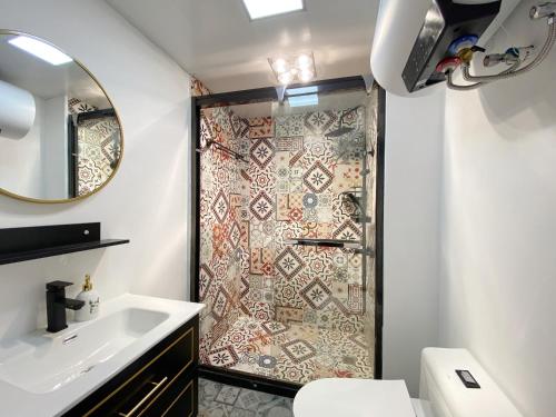 a bathroom with a shower with a toilet and a sink at 上海Zighouse人民广场店 People's Square Branch, Shanghai in Shanghai