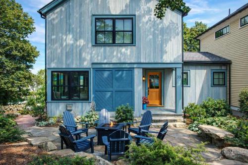 a blue house with chairs and a table at Stay at Old Garden Beach in Rockport