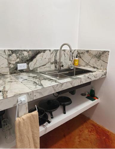 a kitchen counter with a sink and a stove at Casa Tamarindo in San Carlos
