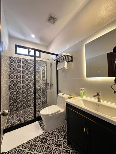 a bathroom with a toilet and a sink and a shower at The TARA PRABANG - Luangprabang in Luang Prabang