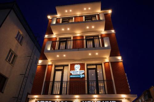 a tall building with a sign on it at night at Chill House in Kutaisi