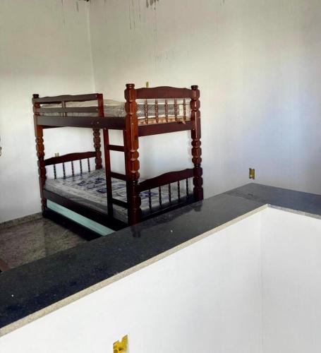 two bunk beds sitting on top of a shelf at Flat Recanto Brados in Sao Jorge